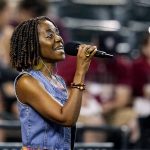 
              Erahn Stinson sings "Lift Every Voice and Sing" as part of the Juneteenth celebration prior to a baseball game between the Arizona Diamondbacks and the Minnesota Twins on Saturday, June 18, 2022, in Phoenix. (AP Photo/Ross D. Franklin)
            