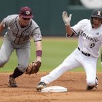 
              Louisville's Christian Knapczyk (9) reacts as he slides safely into second with a double as Texas A&M infielder Ryan Targac (16) tries to apply a late tag during an NCAA college baseball super regional tournament game Saturday, June 11, 2022, in College Station, Texas. (AP Photo/Sam Craft)
            