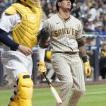 
              San Diego Padres' Manny Machado reacts in front of Milwaukee Brewers catcher Victor Caratini after striking out during the fifth inning of a baseball game Friday, June 3, 2022, in Milwaukee. (AP Photo/Morry Gash)
            