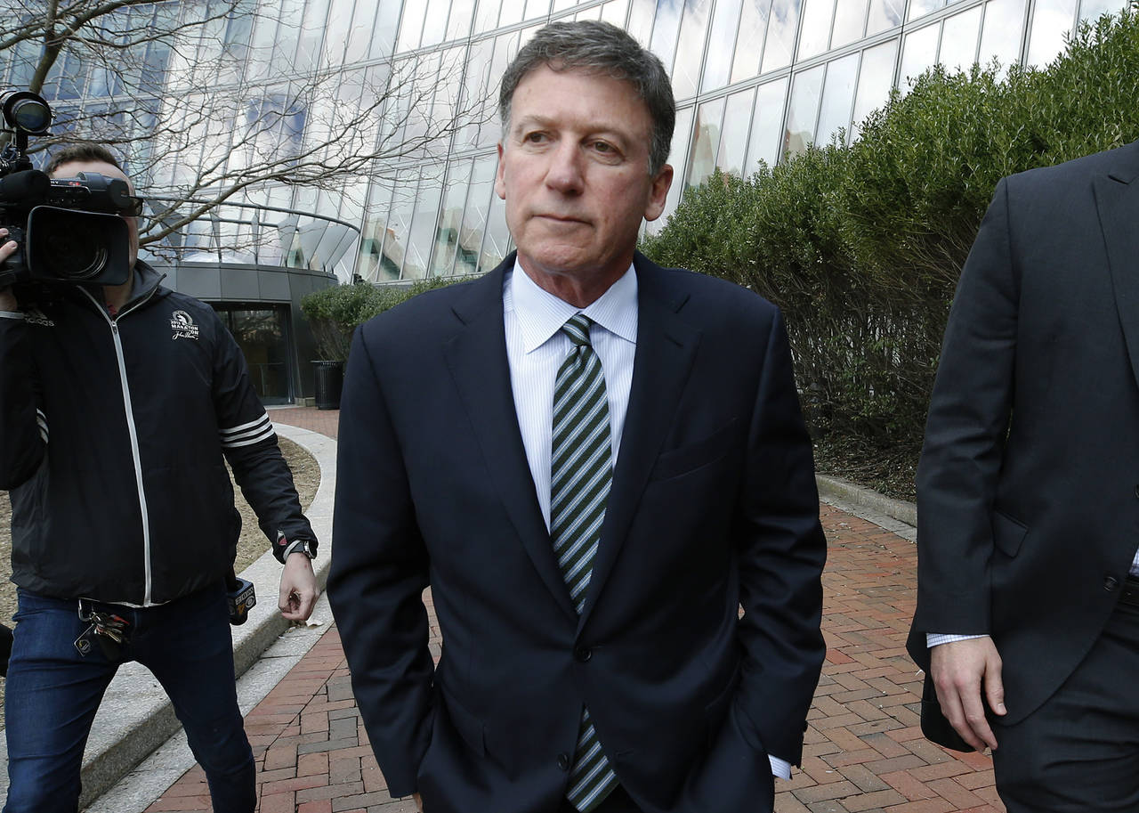 FILE - Bruce Isackson departs federal court, April 3, 2019, in Boston after facing charges in a nat...