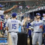 
              Los Angeles Dodgers' Cody Bellinger celebrates after scoring on a double by Chris Taylor during the eleventh inning of a baseball game against the Atlanta Braves on Sunday, June 26, 2022, in Atlanta. The Dodgers won 5-3. (AP Photo/Bob Andres)
            