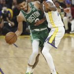 
              CORRECTS TO GAME 2 INSTEAD OF GAME 1 - Boston Celtics forward Jayson Tatum, left, is defended by Golden State Warriors forward Andrew Wiggins during the second half of Game 2 of basketball's NBA Finals in San Francisco, Sunday, June 5, 2022. (AP Photo/Jed Jacobsohn)
            