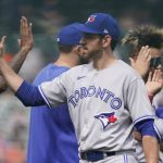 
              Toronto Blue Jays relief pitcher Jordan Romano high fives teammates after the ninth inning of a baseball game against the Detroit Tigers, Sunday, June 12, 2022, in Detroit. (AP Photo/Carlos Osorio)
            