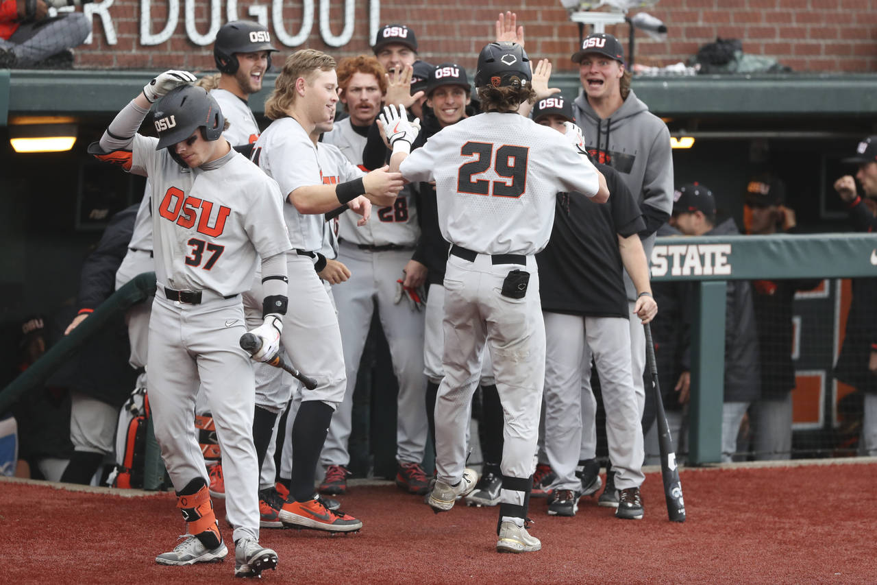 Oregon State players congratulate Jacob Melton on his home run during the fourth inning of an NCAA ...