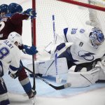 
              Tampa Bay Lightning goaltender Andrei Vasilevskiy, right, deflects a shot off the stick of Colorado Avalanche left wing Gabriel Landeskog (92) as Tampa Bay left wing Ondrej Palat defends during the third period of Game 5 of the NHL hockey Stanley Cup Final, Friday, June 24, 2022, in Denver. (AP Photo/David Zalubowski)
            