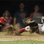 
              Los Angeles Angels' Brandon Marsh loses his helmet as he scores on a double hit by Taylor Ward during the seventh inning of a baseball game Monday, June 27, 2022, in Anaheim, Calif. (AP Photo/Jae C. Hong)
            
