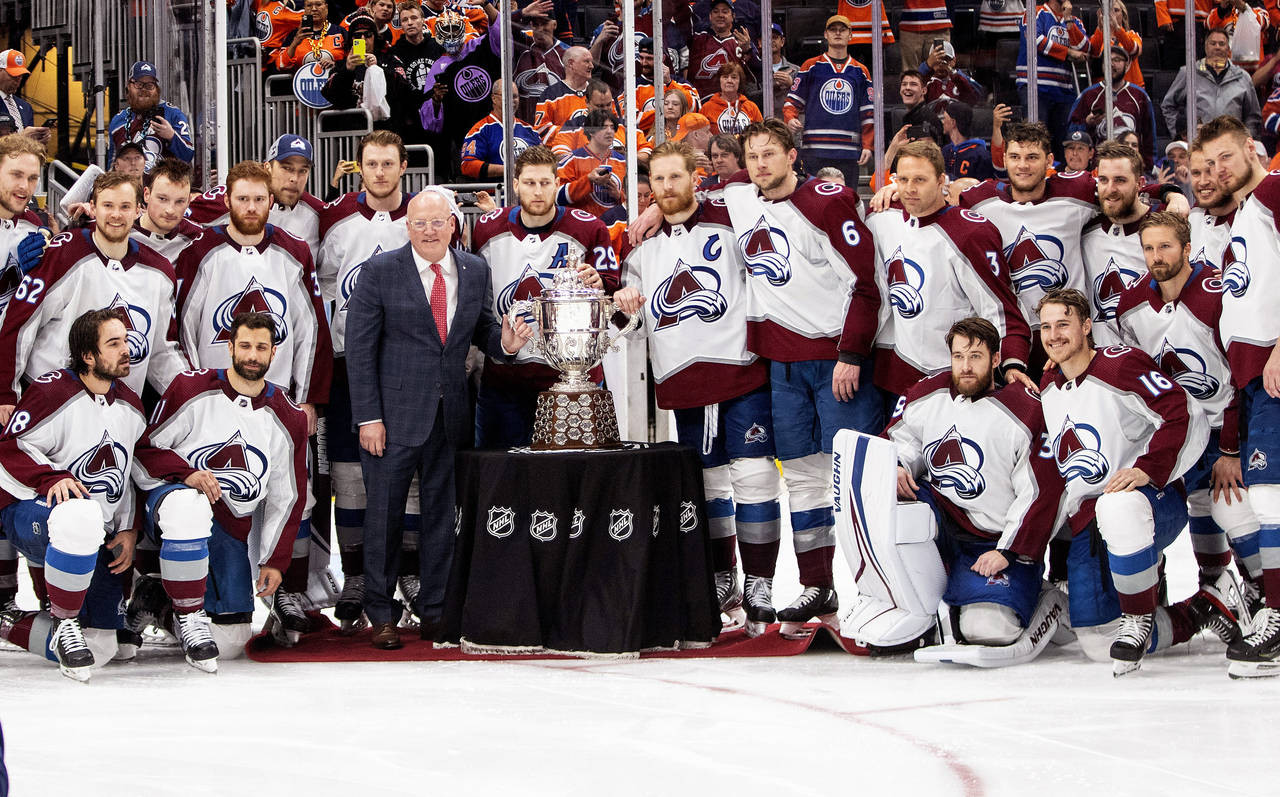 Colorado Avalanche players stand with the Campbell Conference Bowl and Deputy Commissioner Bill Dal...