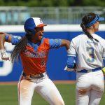 
              Florida's Cheyenne Lindsey (2) celebrates after reaching second base before UCLA infielder Briana Perez (3) could make a tag during the fifth inning of an NCAA softball Women's College World Series game on Sunday, June 5, 2022, in Oklahoma City. (AP Photo/Alonzo Adams)
            