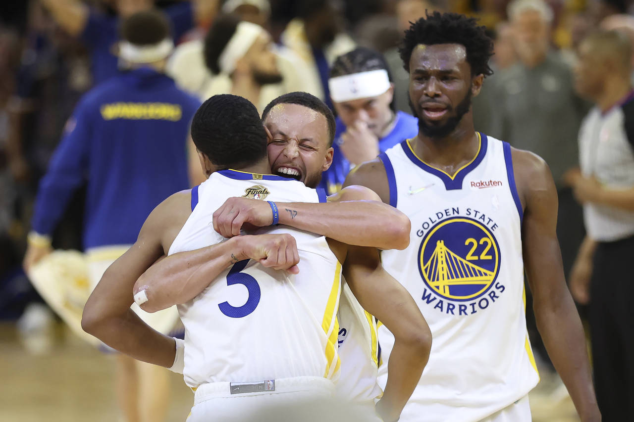 CORRECTS TO GAME 2 INSTEAD OF GAME 1 - Golden State Warriors guard Jordan Poole, left, celebrates w...