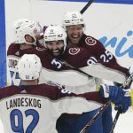 
              Colorado Avalanche center Nazem Kadri (91) is congratulated by teammates after his overtime goal on Tampa Bay Lightning goaltender Andrei Vasilevskiy (88) in Game 4 of the NHL hockey Stanley Cup Finals on Wednesday, June 22, 2022, in Tampa, Fla. (AP Photo/John Bazemore)
            