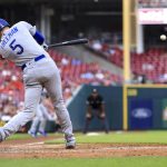 
              Los Angeles Dodgers' Freddie Freeman hits an RBI single against the Cincinnati Reds during the fifth inning of a baseball game in Cincinnati, Wednesday, June 22, 2022. (AP Photo/Aaron Doster)
            