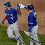 
              Toronto Blue Jays' Santiago Espinal, left, celebrates with Bradley Zimmer (7) after scoring on a double by Raimel Tapia during the seventh inning of a baseball game against the Kansas City Royals Tuesday, June 7, 2022, in Kansas City, Mo. (AP Photo/Charlie Riedel)
            