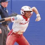 
              Oklahoma's Rylie Boone (0) celebrates at home plate after hitting a home run in the third inning of an NCAA softball Women's College World Series game against Northwestern on Thursday, June 2, 2022, in Oklahoma City. (AP Photo/Alonzo Adams)
            