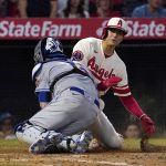 
              Los Angeles Angels' Shohei Ohtani, right, is tagged out at home by New York Mets catcher Tomas Nido as he tries to score on a single by Jared Walsh during the third inning of a baseball game Saturday, June 11, 2022, in Anaheim, Calif. (AP Photo/Mark J. Terrill)
            