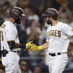 
              San Diego Padres' Eric Hosmer, right, is congratulated by Nomar Mazara after scoring against the Philadelphia Phillies during the sixth inning of a baseball game Friday, June 24, 2022, in San Diego. (AP Photo/Derrick Tuskan)
            