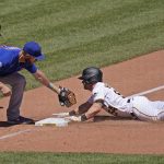 
              Pittsburgh Pirates' Tyler Heineman, right, slides safely into third under the tag attempt by Chicago Cubs third baseman Patrick Wisdom during the sixth inning of a baseball game in Pittsburgh, Thursday, June 23, 2022. (AP Photo/Gene J. Puskar)
            