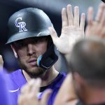 
              Colorado Rockies' C.J. Cron is congratulated in the dugout after scoring on a double hit by Ryan McMahon during the fifth inning of a baseball game against the Miami Marlins, Tuesday, June 21, 2022, in Miami. (AP Photo/Lynne Sladky)
            