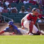 
              Chicago Cubs' Nelson Velazquez, left, scores past St. Louis Cardinals catcher Andrew Knizner during the 10th inning of a baseball game Sunday, June 26, 2022, in St. Louis. (AP Photo/Jeff Roberson)
            
