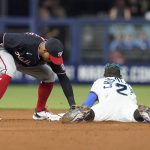 
              Washington Nationals second baseman Cesar Hernandez tags Miami Marlins Jazz Chisholm Jr. (2) as he tries to steal second base in the fifth inning of a baseball game, Wednesday, June 8, 2022, in Miami. (AP Photo/Marta Lavandier)
            