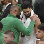 
              Boston Celtics head coach Ime Udoka, left, talks with forward Jayson Tatum (0) after beating the Golden State Warriors in Game 3 of basketball's NBA Finals, Wednesday, June 8, 2022, in Boston. (AP Photo/Steven Senne)
            