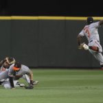 
              Baltimore Orioles centerfielder Cedric Mullins, left, makes a catch on a ball hit by Seattle Mariners' Taylor Trammell after near collisions with Baltimore Orioles rightfielder Austin Hays, and shortstop Jorge Mateo, right, during the sixth inning of a baseball game, Monday, June 27, 2022, in Seattle. (AP Photo/Stephen Brashear)
            