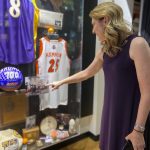 
              Debbie Antonelli, a 2022 inductee into the Women's Basketball Hall of Fame as a contributor points at a photo of her college coach North Carolina State's Kay Yow, Saturday, June 11, 2022 in Knoxville, Tenn. Debbie Antonelli, Becky Hammon, Doug Bruno and Penny  Taylor are among the 2022 inductees Saturday night into the Women’s Basketball Hall of Fame. Title IX also is being honored with the hall’s Trailblazers of the Game award at its 50th anniversary. (AP Photo/Teresa M. Walker)
            