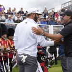 
              Dustin Johnson of the United States, left, and Phil Mickelson of the United States greet each other on the first tee during the first round of the inaugural LIV Golf Invitational at the Centurion Club in St. Albans, England, Thursday, June 9, 2022. (AP Photo/Alastair Grant)
            