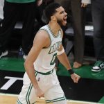 
              Boston Celtics forward Jayson Tatum (0) reacts after hitting a three-point shot against the Golden State Warriors during the first quarter of Game 4 of basketball's NBA Finals, Friday, June 10, 2022, in Boston. (AP Photo/Michael Dwyer)
            