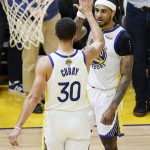 
              Golden State Warriors guard Stephen Curry (30) celebrates with guard Gary Payton II during the second half of Game 5 of basketball's NBA Finals against the Boston Celtics in San Francisco, Monday, June 13, 2022. (AP Photo/John Hefti)
            