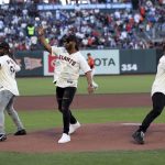 
              San Francisco 49ers' Azeez Al-Shaair, left, Fred Warner, center and Dre Greenlaw, right, throw ceremonial first pitches before a baseball game between the San Francisco Giants and the Los Angeles Dodgers in San Francisco, Friday, June 10, 2022. (AP Photo/Jed Jacobsohn)
            