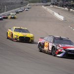 
              Kyle Busch (18) enters Turn 1 followed by Joey Logano (22) during a NASCAR Cup Series auto race at World Wide Technology Raceway, Sunday, June 5, 2022, in Madison, Ill. (AP Photo/Jeff Roberson)
            