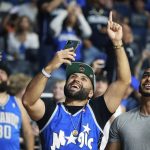 
              David Nejad, middle, and other fans react during an NBA basketball draft watch party after the Orlando Magic selected Duke's Paolo Banchero with the first pick in the draft Thursday, June 23, 2022. (Stephen M. Dowell/Orlando Sentinel via AP)
            