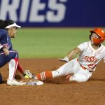 
              Arizona's Sophia Carroll (00) tags out Oklahoma State's Sydney Pennington (21) during the third inning of an NCAA softball Women's College World Series game Thursday, June 2, 2022, in Oklahoma City. (AP Photo/Alonzo Adams)
            