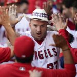 
              Los Angeles Angels' Mike Trout (27) celebrates in the dugout after hitting a home run during the first inning of a baseball game against the Boston Red Sox in Anaheim, Calif., Tuesday, June 7, 2022. Shohei Ohtani also scored. (AP Photo/Ashley Landis)
            