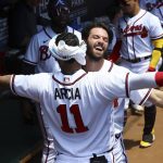 
              Atlanta Braves' Dansby Swanson, right, gets a chest bump in the dugout from Orlando Arcia after after hitting a lead-off home run in the first inning of a baseball game against the San Francisco Giants on Thursday, June 23, 2022, in Atlanta. (Curtis Compton/Atlanta Journal-Constitution via AP)
            