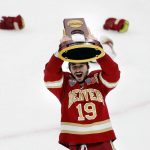 
              FILE - Denver's Cole Guttman holds up the trophy after Denver defeated Minnesota State in the NCAA men's Frozen Four championship college hockey game April 9, 2022, in Boston. The Mile High City is now home to the Stanley Cup, NCAA and national high school champions.  (AP Photo/Michael Dwyer, File)
            