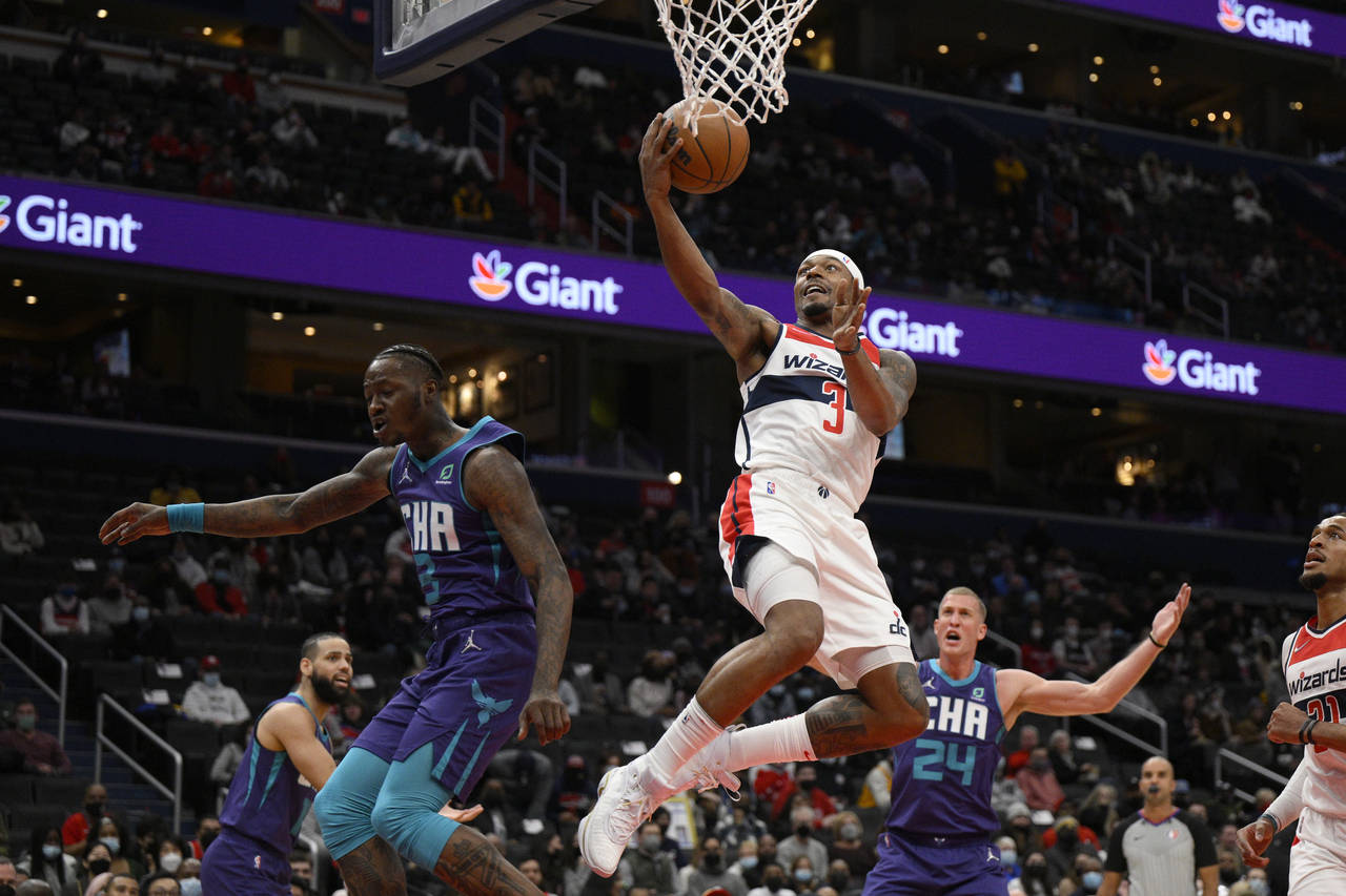 FILE - Washington Wizards guard Bradley Beal, center, goes to the basket against Charlotte Hornets ...