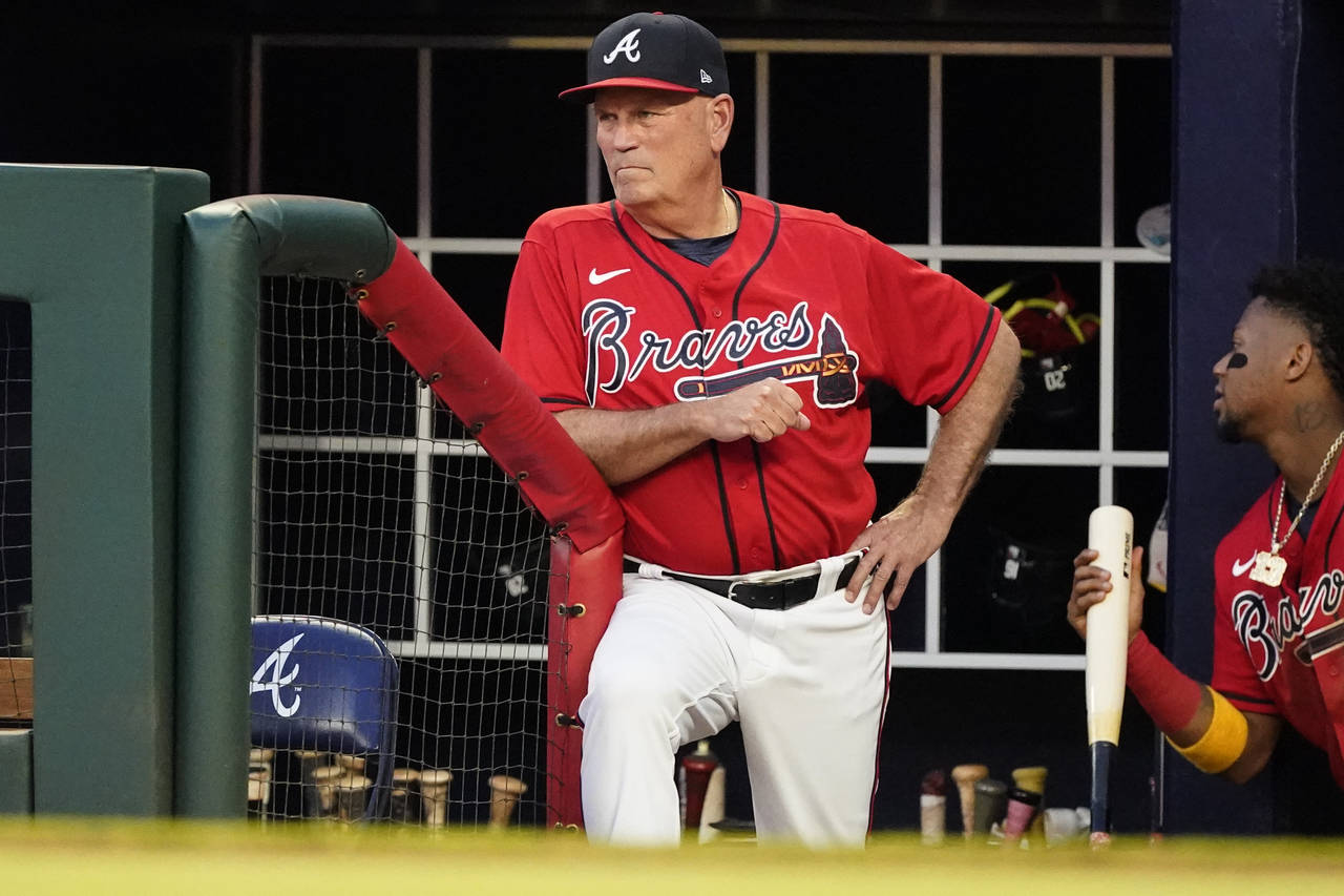 Atlanta Braves manager Brian Snitker watches from the dugout as the team plays against the Pittsbur...