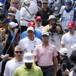 
              Justin Thomas, center, makes his way through the crowd on his way to the second tee during the fourth round of the Canadian Open golf tournament in Toronto on Sunday, June 12, 2022. (Frank Gunn/The Canadian Press via AP)
            