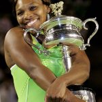 
              FILE - Serena Williams hugs the Australian Open trophy after defeating Maria Sharapova of Russia in their women's singles final match at the Australian Open tennis tournament in Melbourne, Australia, Saturday, Jan. 27, 2007. Williams won the final, 6-1 6-2. The 2022 Wimbledon competition is not the first comeback from a significant absence for Williams. (AP Photo/Rick Stevens, File)
            