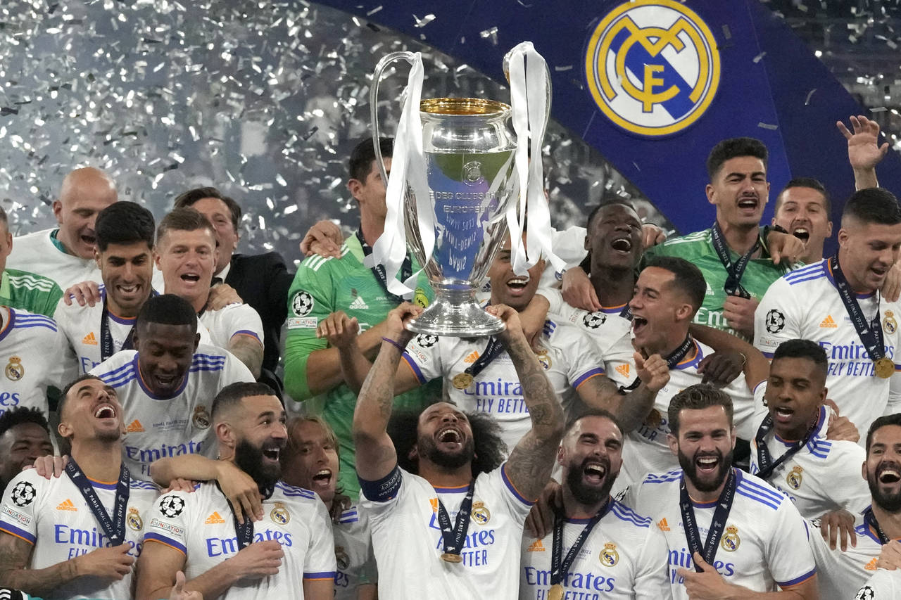 Real Madrid's Marcelo lifts the trophy as players celebrate winning the Champions League final socc...