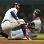 
              Oakland Athletics' Matt Davidson (4) slides on an attempted steal of second base, as Atlanta Braves shortstop Dansby Swanson (7) waits for the throw before making the tag in the third inning of a baseball game Wednesday, June 8, 2022, in Atlanta. (AP Photo/John Bazemore)
            