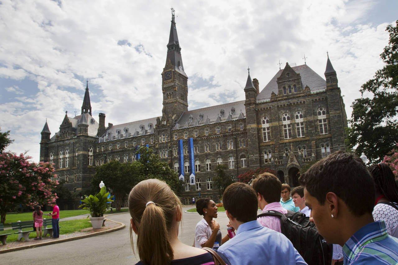 FILE - Prospective students tour Georgetown University's campus, on July 10, 2013, in Washington. A...