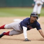 
              Boston Red Sox's Xander Bogaerts slides safely into third base during the eighth inning of a baseball game against the Oakland Athletics in Oakland, Calif., Saturday, June 4, 2022. (AP Photo/Jeff Chiu)
            