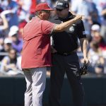 
              Oklahoma head coach Skip Johnson, left, argues with the umpire after a run was taken back due to interference against Mississippi by an Oklahoma first base runner in the sixth inning in Game 2 of the NCAA College World Series baseball finals, Sunday, June 26, 2022, in Omaha, Neb. (AP Photo/Rebecca S. Gratz)
            