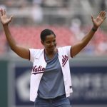 
              FILE - Soccer legend Briana Scurry reacts after she threw out the ceremonial first pitch before a baseball game between the Washington Nationals and the Milwaukee Brewers, Saturday, June 11, 2022, in Washington. Title IX paved the way for the Black goalkeeper to to knock down barriers with her talent, determination and grit, amassing a long list of honors in what was a predominantly white sport. (AP Photo/Nick Wass, File)
            