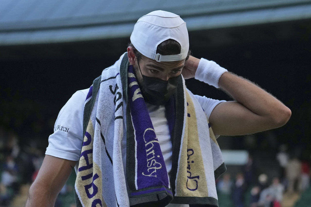 FILE - Italy's Matteo Berrettini wears a mask at the end of the third set during the men's singles ...