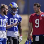 
              Los Angeles Rams wide receiver Cooper Kupp, left, talks with quarterback Matthew Stafford, right, as wide receiver Lance McCutcheon stands by during an NFL mini camp football practice Wednesday, June 8, 2022, in Thousand Oaks, Calif. (AP Photo/Mark J. Terrill)
            