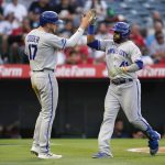 
              Kansas City Royals' Carlos Santana (41) celebrates with designated hitter Hunter Dozier (17) after hitting a home run during the fourth inning of a baseball game against the Los Angeles Angels in Anaheim, Calif., Tuesday, June 21, 2022. Dozier also scored. (AP Photo/Ashley Landis)
            