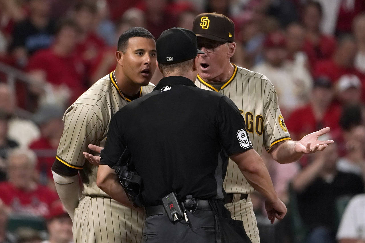 San Diego Padres' Manny Machado, left, and manager Bob Melvin, right, argue with home plate umpire ...